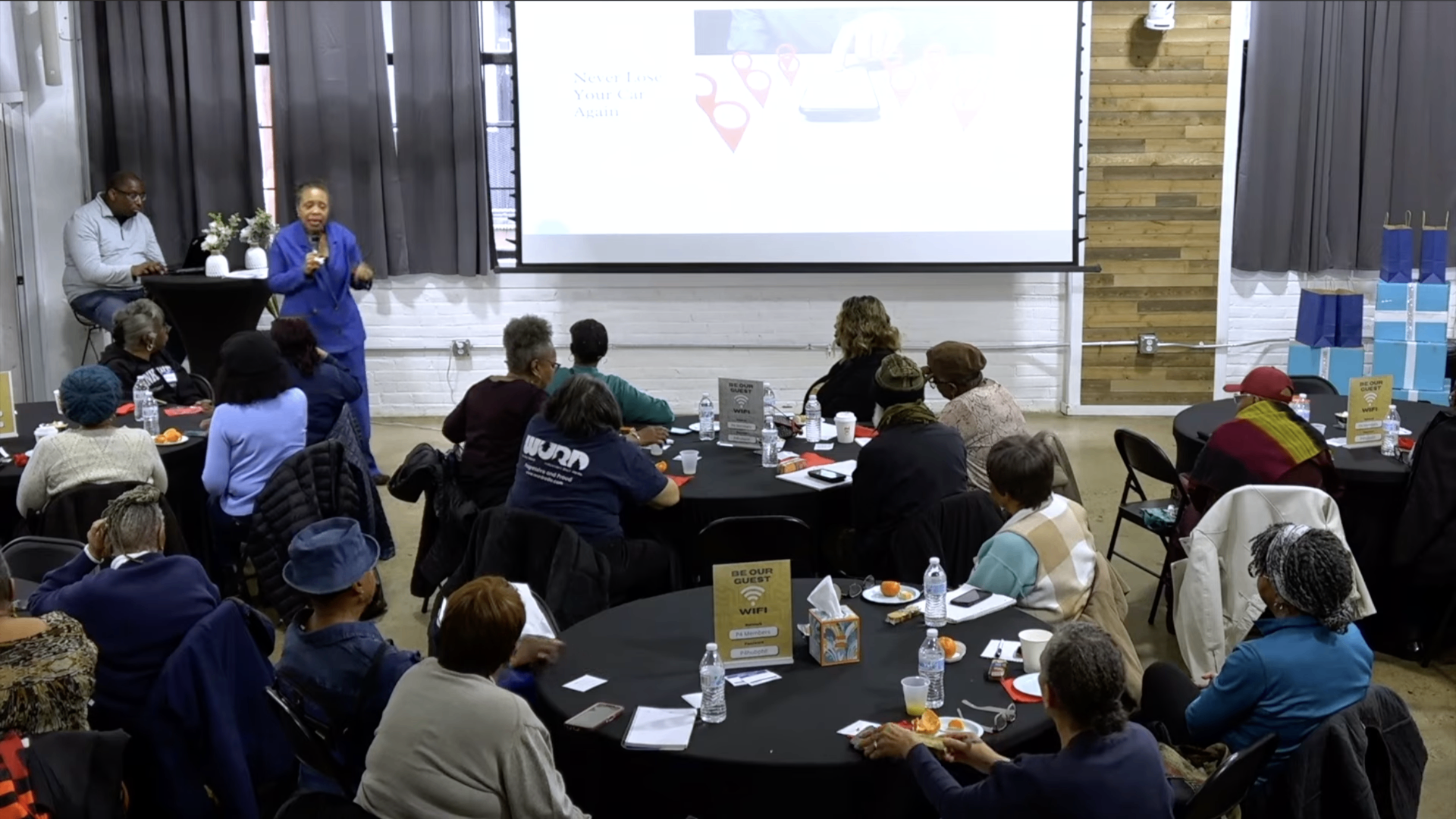 Rozell presenting to a full room